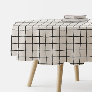 Okrągły obrus z kremowym tłem i czarną, ręcznie malowaną kratą na stole