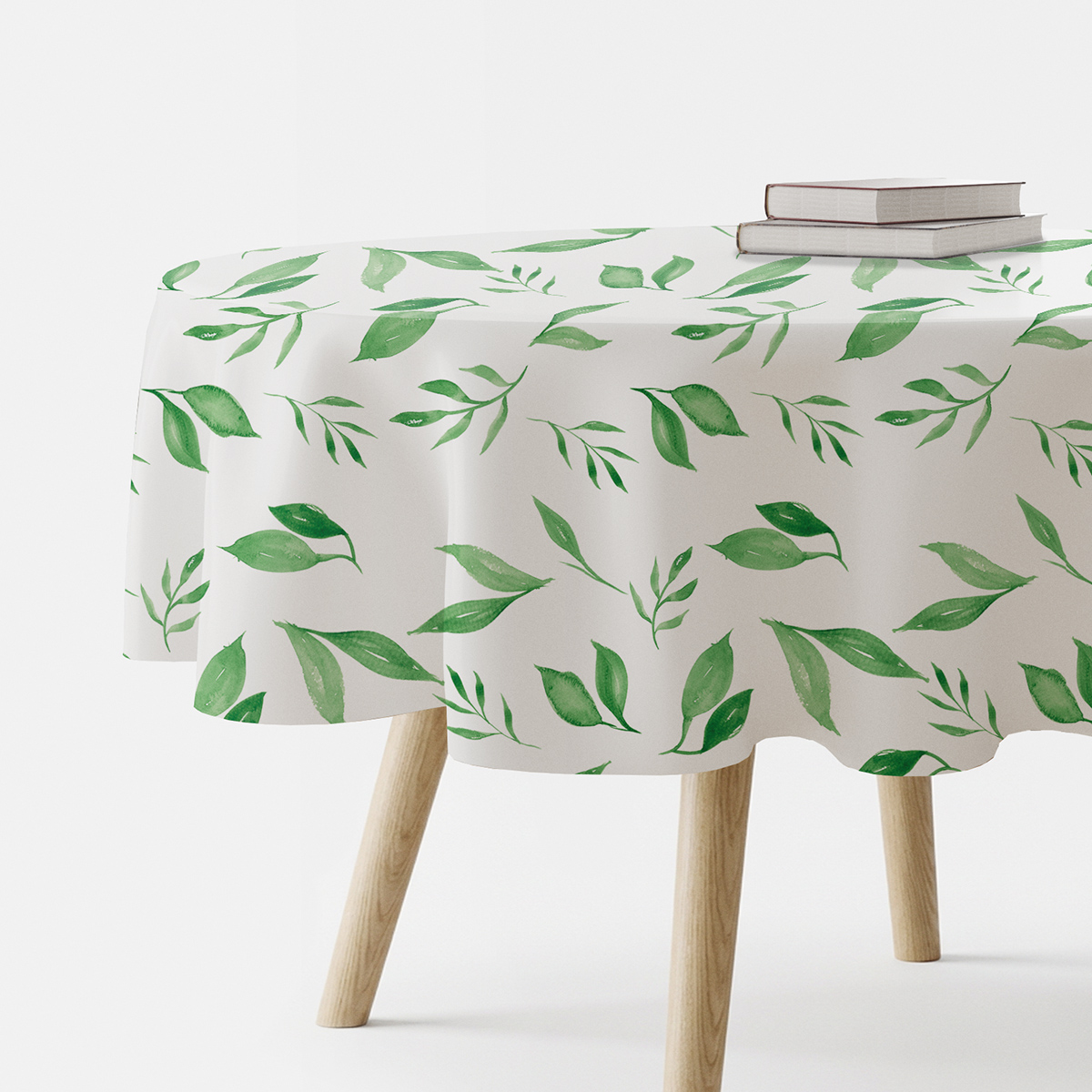 okrągły obrus z akwarelowymi zielonymi listkami na białym tle, widok produktowy