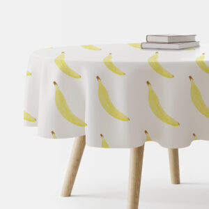 okrągły obrus na stole z powtarzającym się motywem żółtych bananów