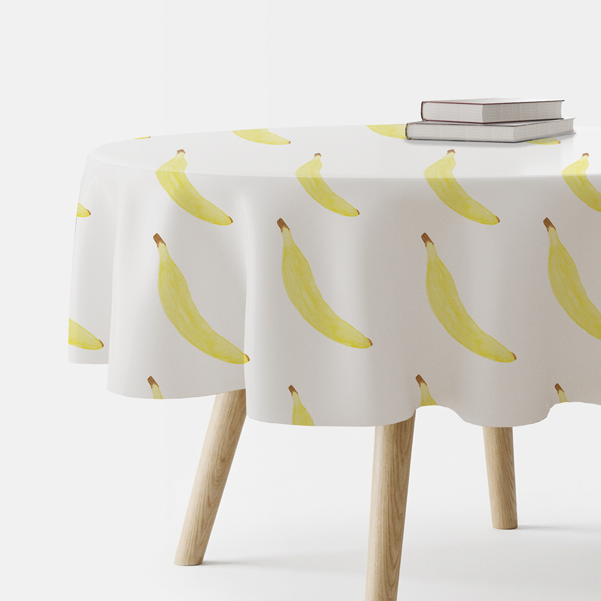 okrągły obrus na stole z powtarzającym się motywem żółtych bananów
