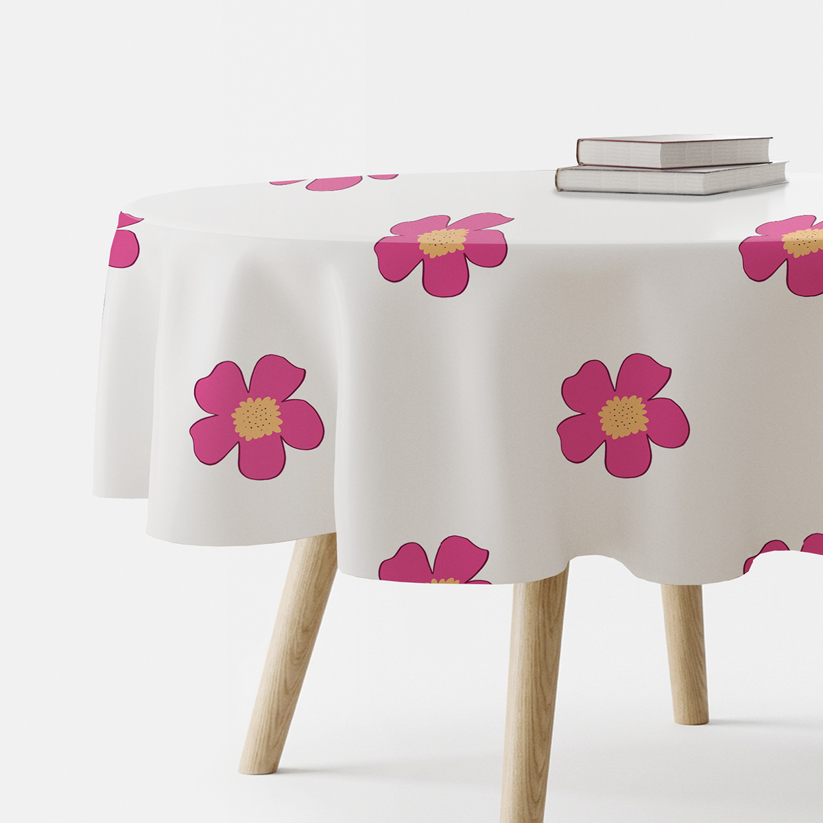 okrągły obrus na stole z dużymi różowymi kwiatami widoczny z boku