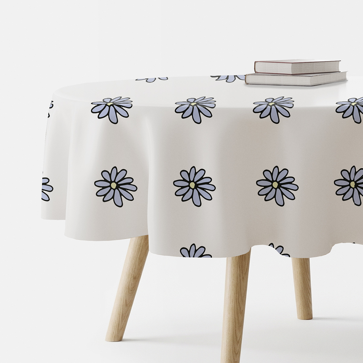 okrągły obrus na stole z rysunkowymi stokrotkami widok z boku
