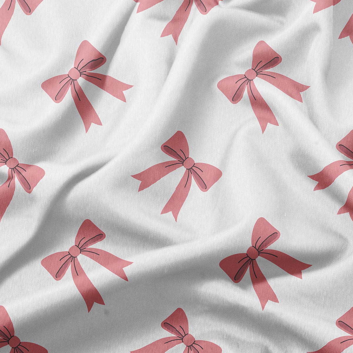 zbliżenie tkaniny z motywem różowych kokardek i delikatną fakturą materiału