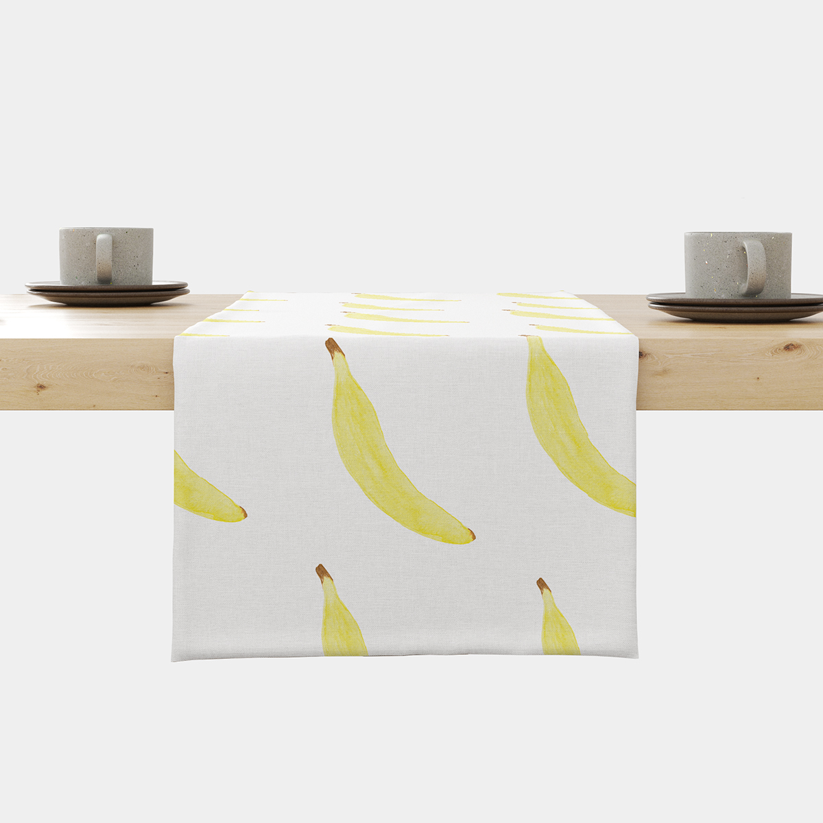 Bieżnik z motywem żółtych bananów rozłożony na drewnianym stole w stylowej aranżacji