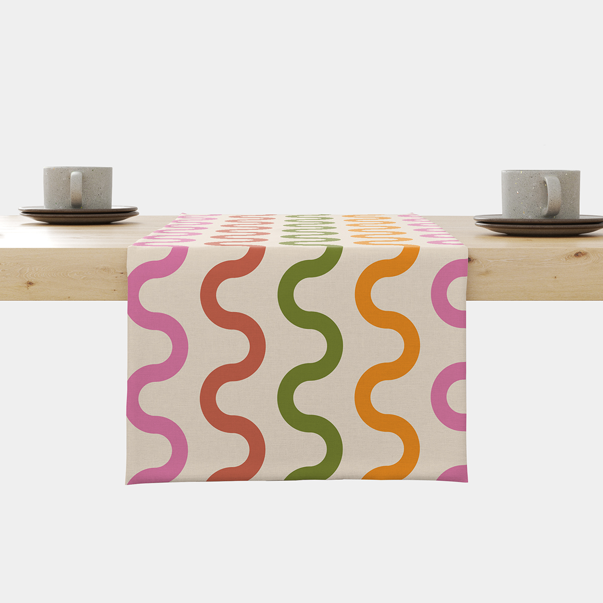 Bieżnik rozłożony na stole z kremowym tłem i rzędami fal w różowych, czerwonych, zielonych i pomarańczowych kolorach