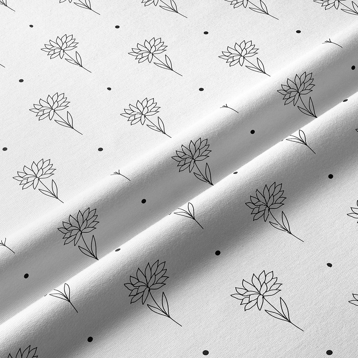 zbliżenie na delikatny, ręcznie szkicowany motyw kwiatu i drobne kropki na tkaninie