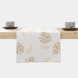 Bieżnik ułożony na krawędzi stołu z delikatnym złotym motywem gałązek