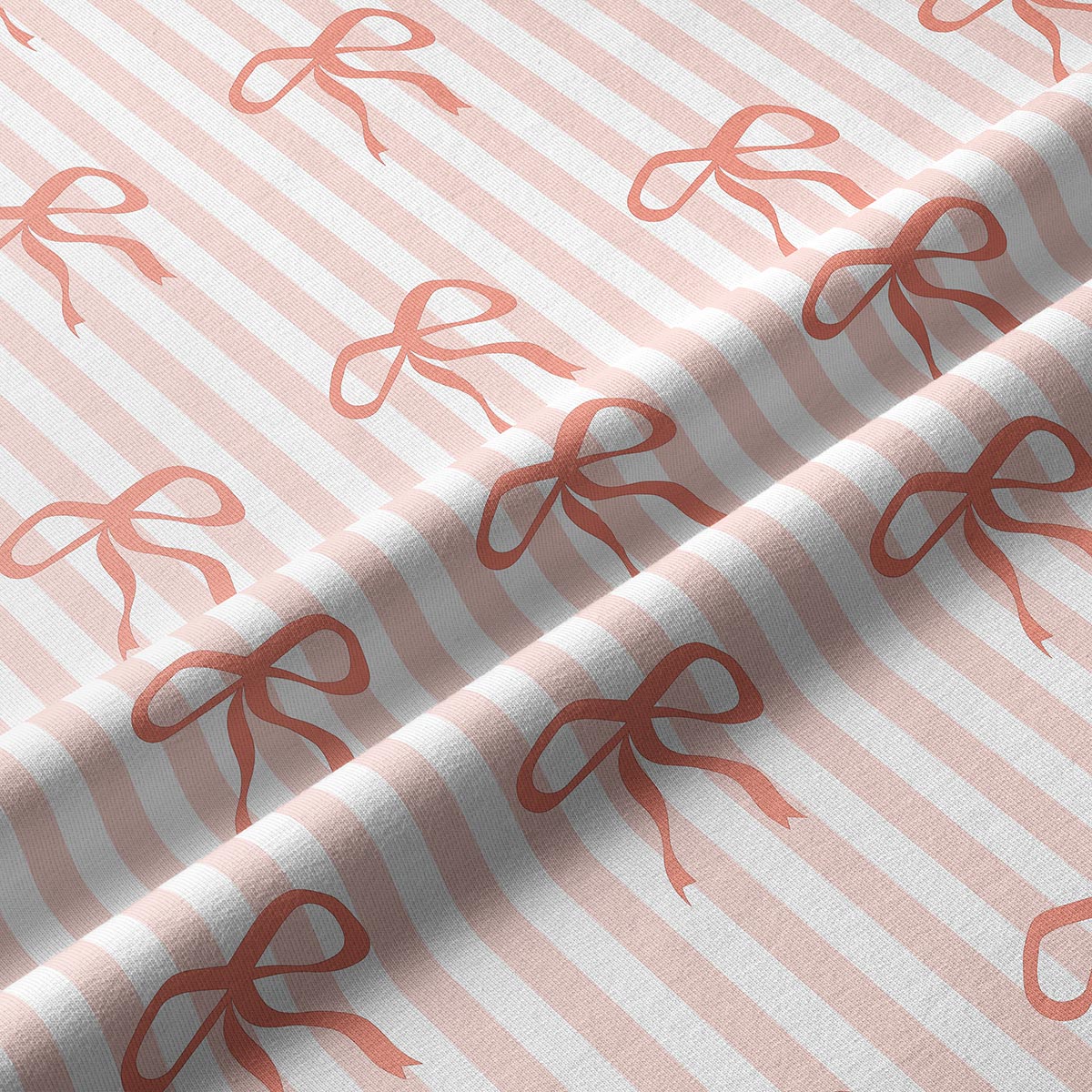 Zbliżenie na fakturę tkaniny i powtarzający się wzór kokardek na paskach