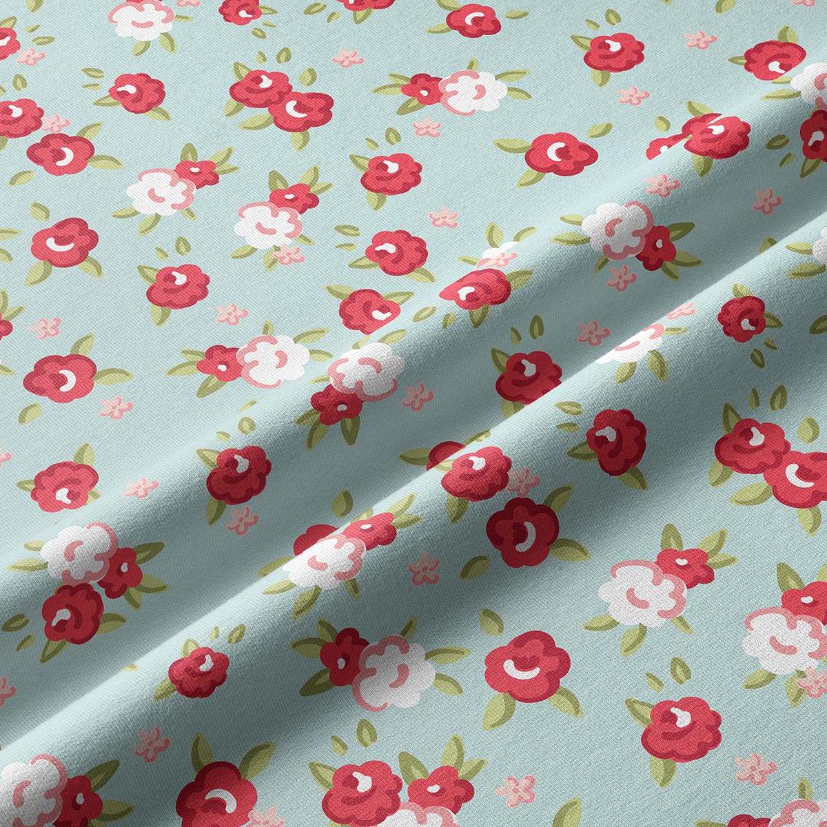 zbliżenie na fakturę tkaniny i drobny wzór różyczek na miętowym tle