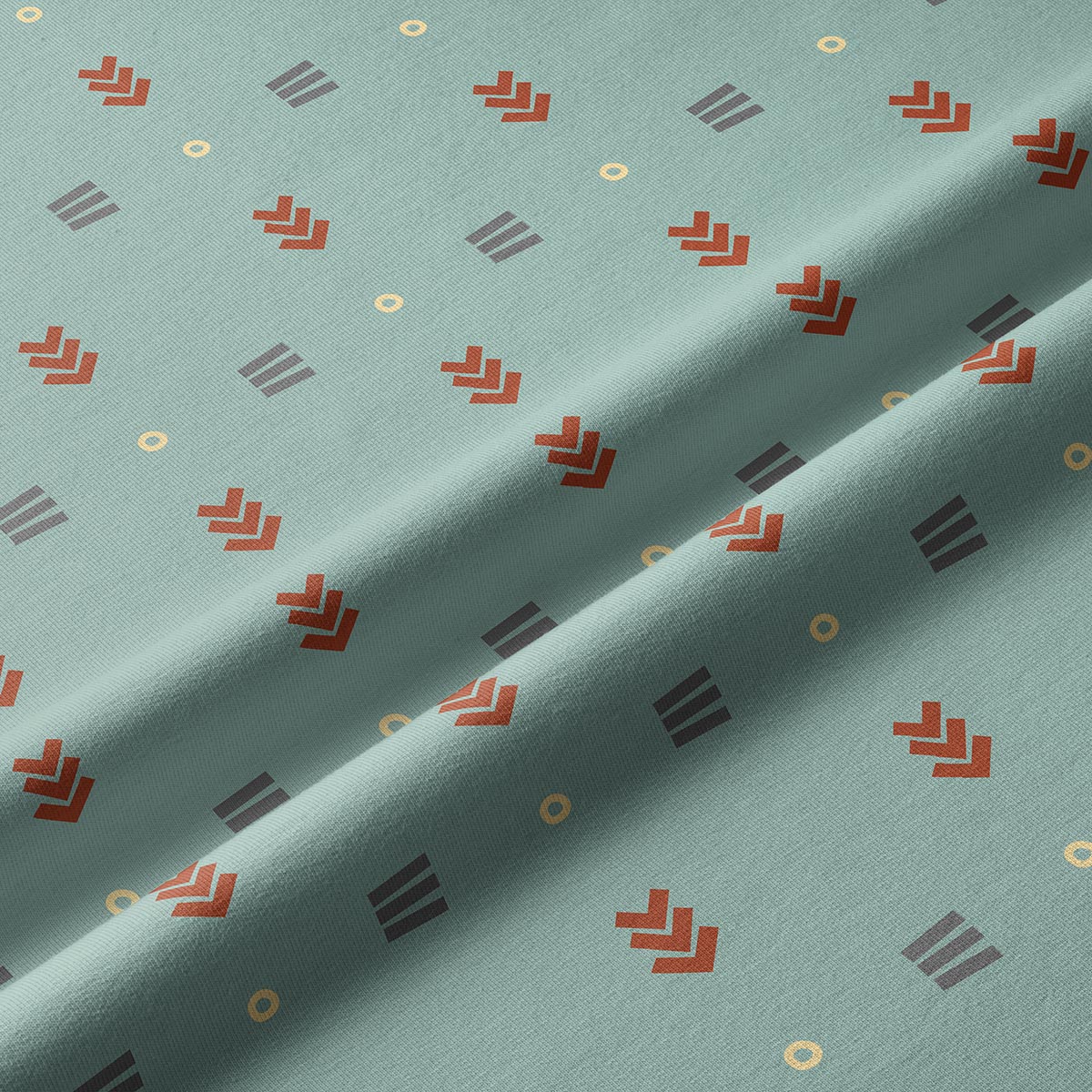 Zbliżenie na teksturę tkaniny i detale wzoru: strzałki, paski i drobne kółka