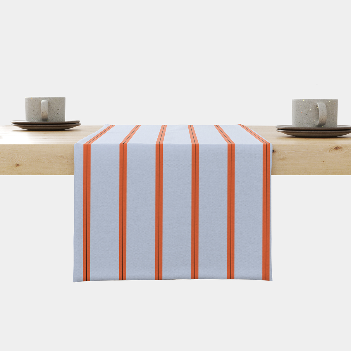 Bieżnik rozłożony na stole z jasnoniebieskim tłem i pomarańczowymi pionowymi pasami, główne ujęcie