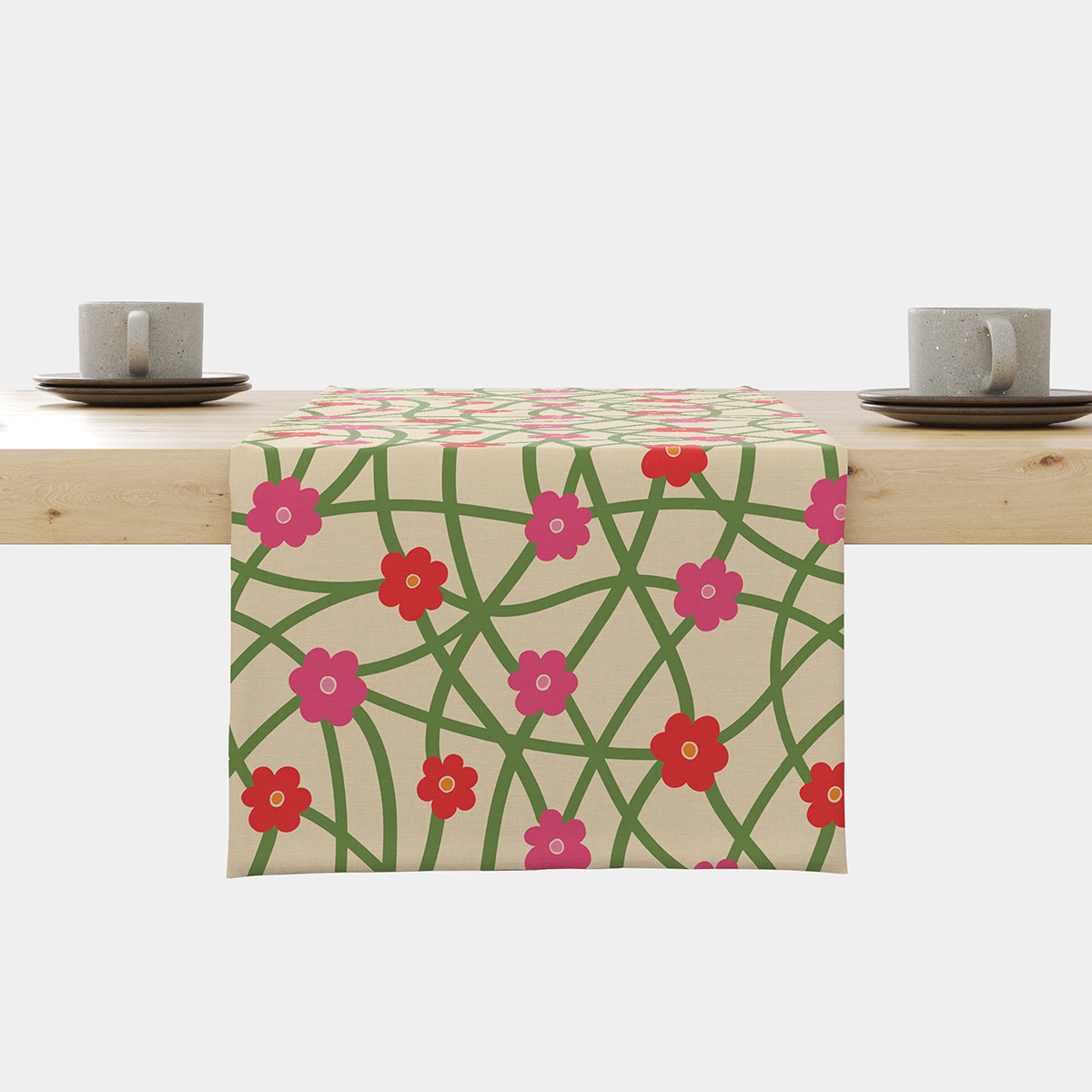 Bieżnik ułożony na stole z widocznym wzorem zielonej sieci i różowo-czerwonych kwiatków