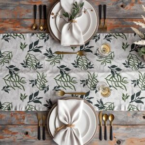 Aranżacja stołu z bieżnikiem, talerze, złote sztućce i szklanki na wzorze