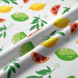 Zbliżenie na materiał z detalami liści i owoców, widoczna faktura tkaniny i żywe kolory