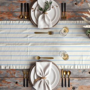 aranżacja stołu z talerzami, złotymi sztućcami i bieżnikiem w pasy