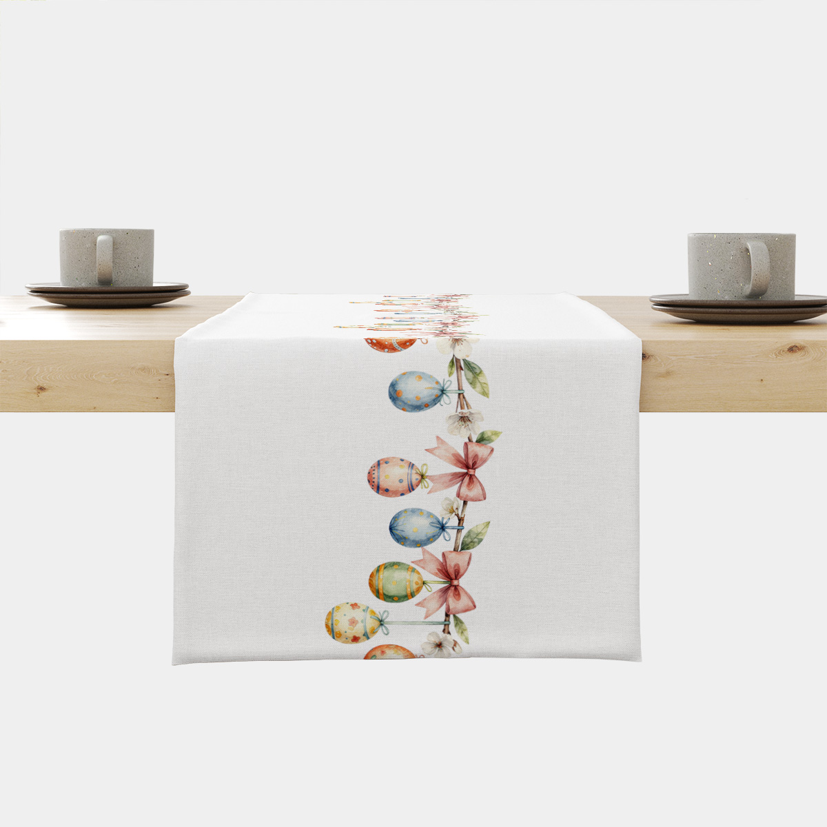 Bieżnik z dekoracyjnym pasem malowanych pisanek i różowych kokard na białym tle, ujęcie główne