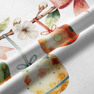 Zbliżenie na detale tkaniny: akwarelowe pisanki, pąki kwiatów i przewiązane kokardy