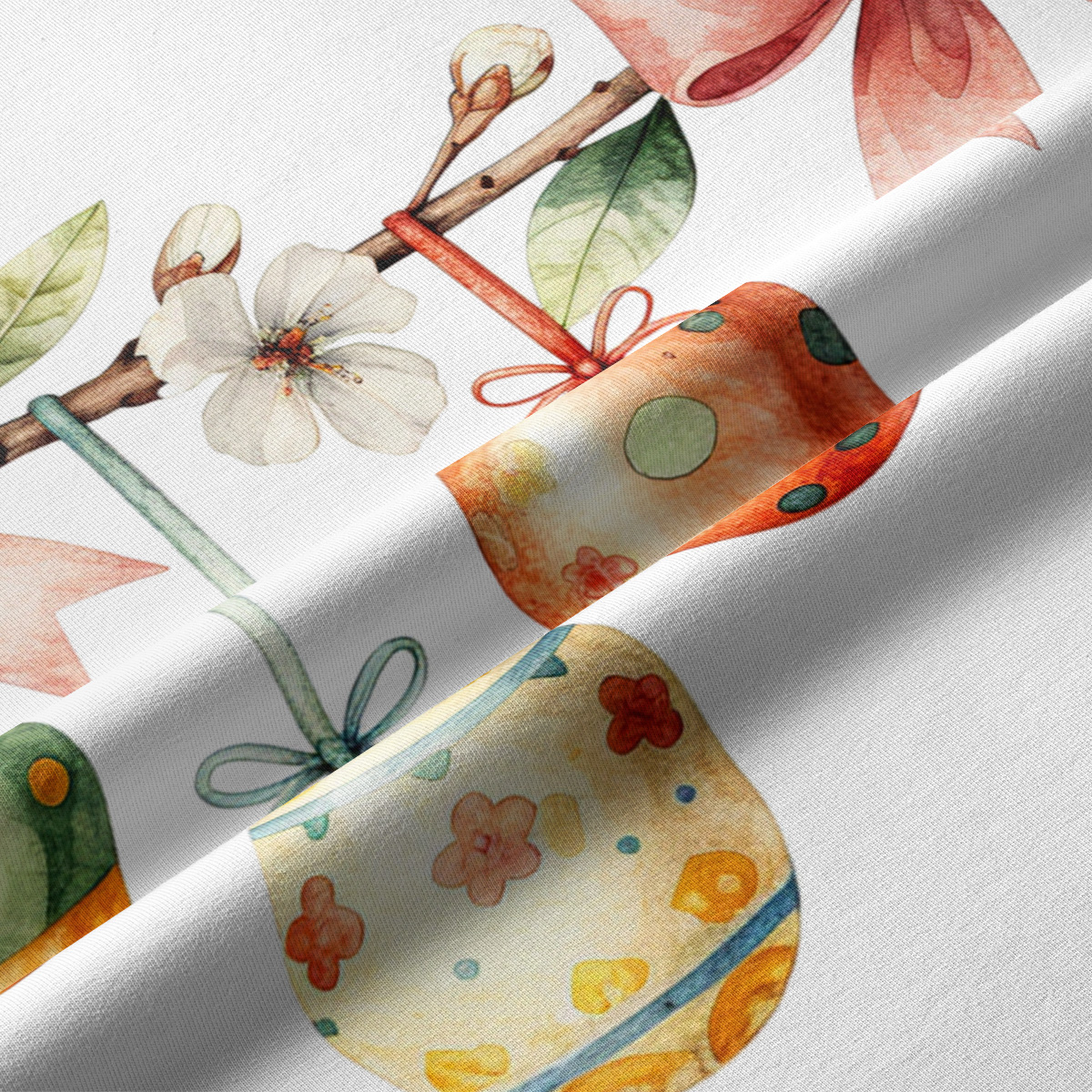 Zbliżenie na detale tkaniny: akwarelowe pisanki, pąki kwiatów i przewiązane kokardy