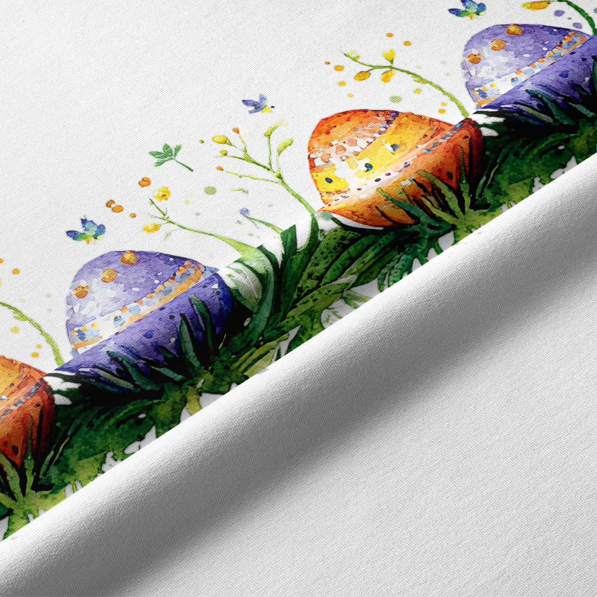 Zbliżenie na akwarelowe pisanki i szczegóły druku na tkaninie