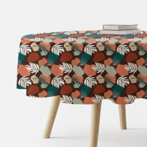 okrągły obrus na stole z liściastymi motywami i organicznymi plamami