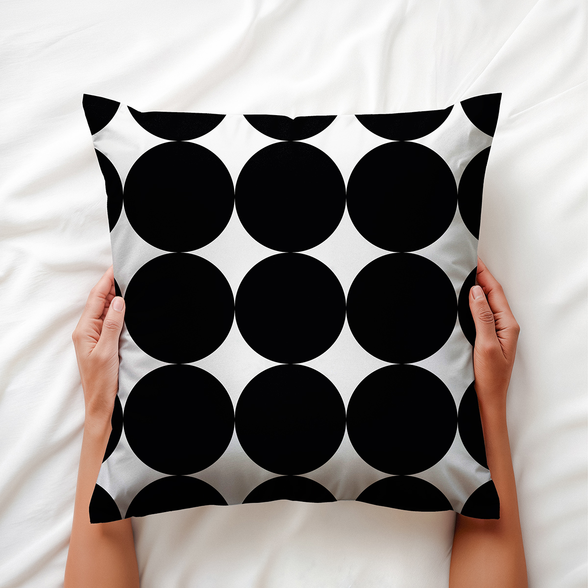 Ręce trzymające poduszkę z geometrycznym wzorem kółek — detale nadruku i faktury