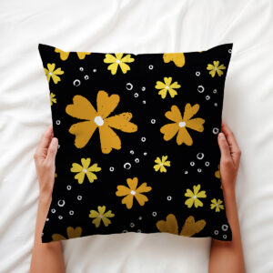 ręce trzymające poduszkę z motywem żółtych kwiatów, zbliżenie na nadruk