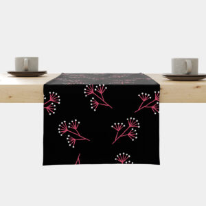 Bieżnik rozłożony na stole z czarnym tłem i regularnym wzorem różowych gałązek oraz białych kropek