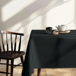 jadalnia z czarnym obrusem przy drewnianych krzesłach i naturalnym światłem