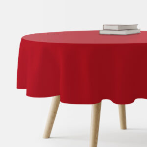 okrągły stół przykryty czerwonym gładkim obrusem z książkami na blacie