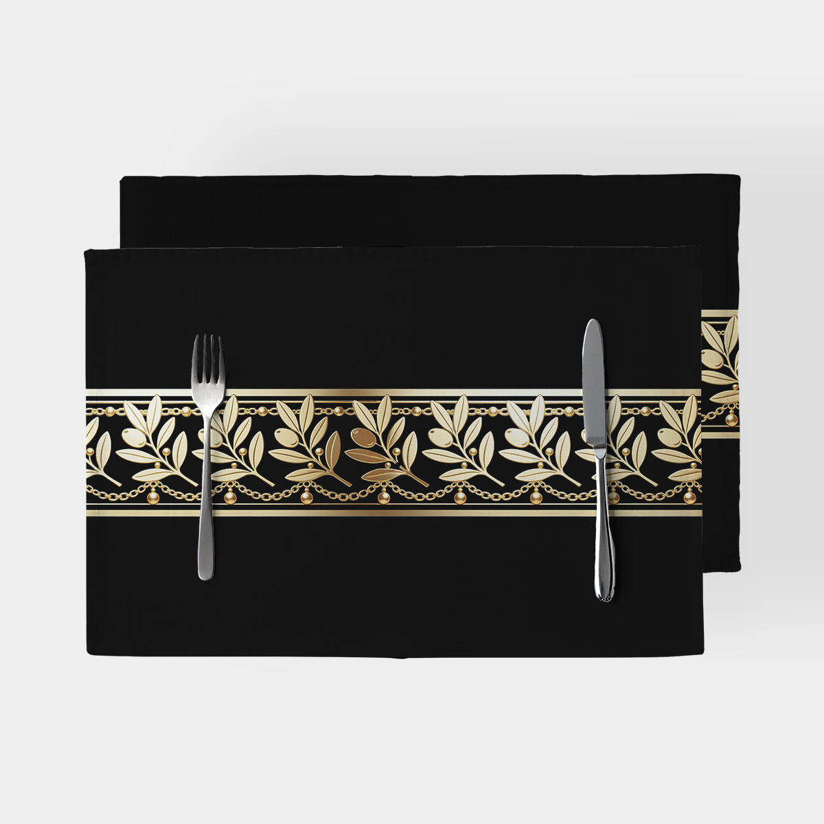 czarne podkładki ze złotym wzorem gałązek i łańcuszków ułożone jedna na drugiej, widok z góry