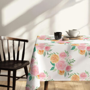 Stół udekorowany gałązkami bawełny i słodkim deserem na obrusie kwiatowym