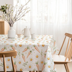 Stół udekorowany obrusem z marchewkami i stokrotkami, inspiracja dekoracją świąteczną