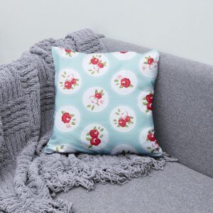 Poduszka ozdobna ułożona na szarej kanapie obok pledu, stylowa aranżacja