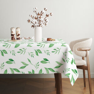 Stół z obrusem ozdobiony wazonem z kwiatami bawełny i prostymi naczyniami