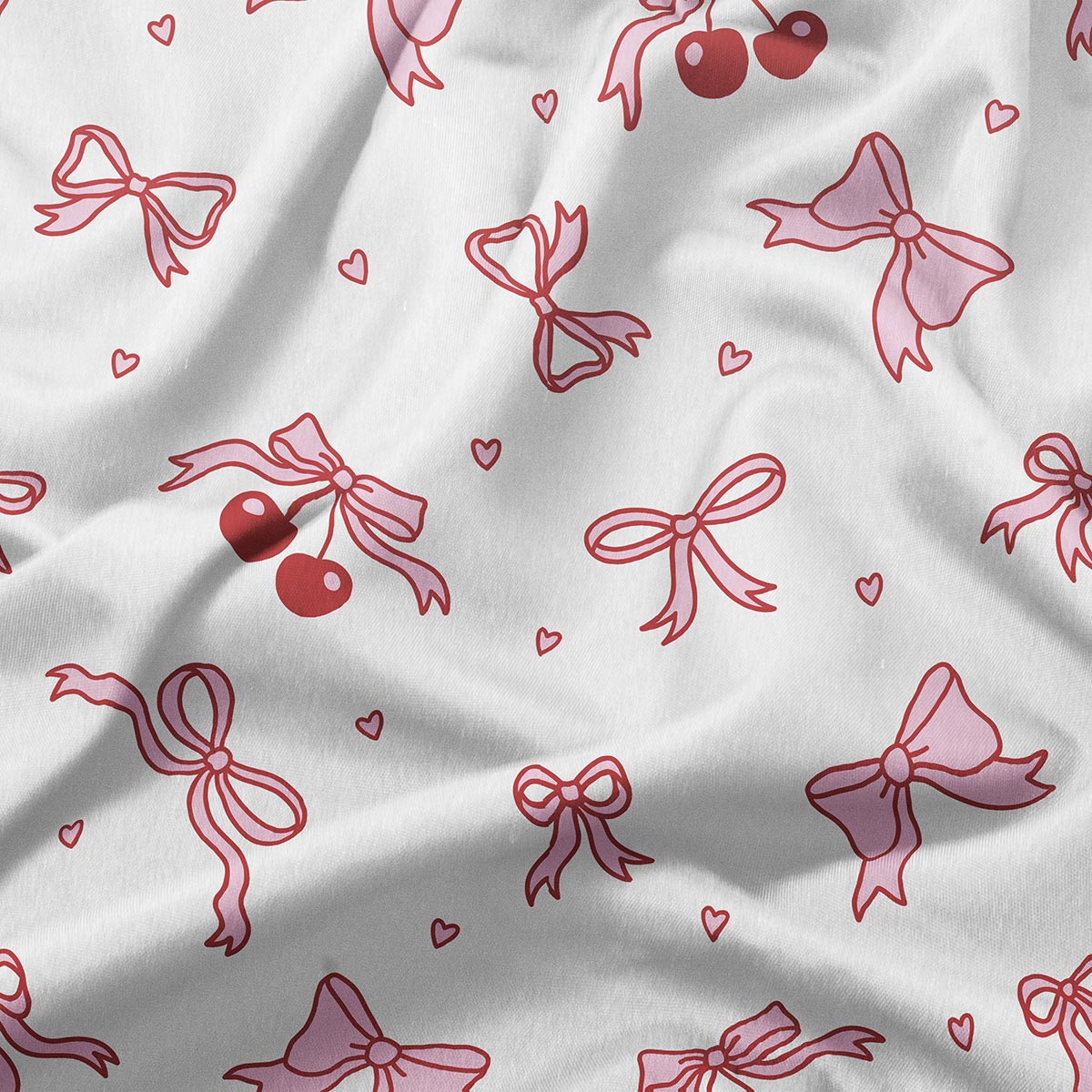 Zbliżenie na tkaninę z detalami kokardek, wisienek i maleńkich serduszek