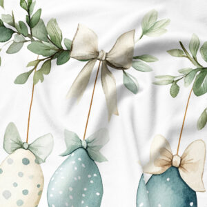 Zbliżenie na detal nadruku: kokarda, zielone gałązki i pastelowe pisanki na tkaninie