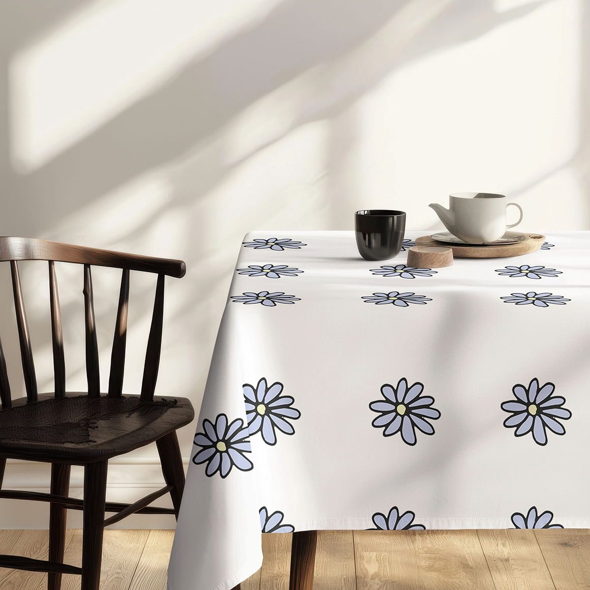 bok stołu z wyraźnym wzorem stokrotek przy krawędzi obrusu