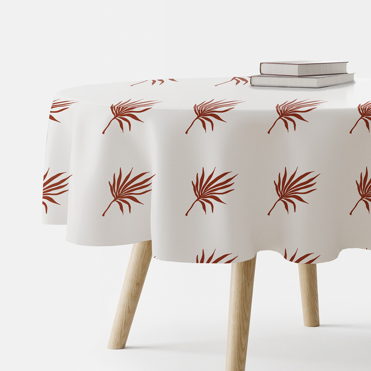 Okrągły obrus na stole z motywem palmowych liści, widok z boku