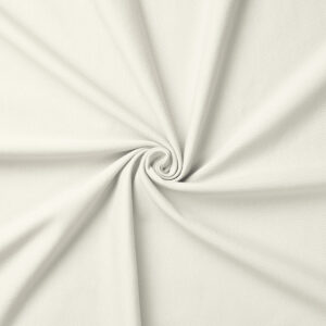 Zbliżenie na fakturę i miękkość kremowej tkaniny obrusowej