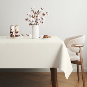 Stół udekorowany gałązkami bawełny i deserami na kremowym obrusie