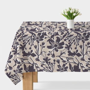 Obrus na stole z beżowym tłem i grafitowym motywem kwiatowym, na środku biały wazon z tulipanami