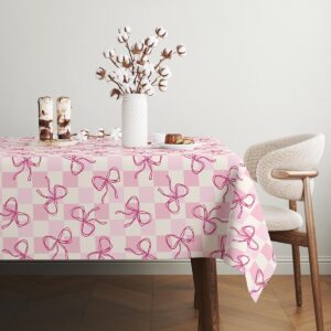 widok stołu z dekoracyjnym wazonem i delikatnym wzorem kokardek na obrusie