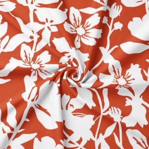 zbliżenie tkaniny pokazujące biały kwiatowy nadruk na ceglastym tle i fakturę materiału