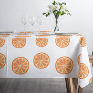 kompozycja stołu w jasnym wnętrzu z obrusem w motyw pomarańczy