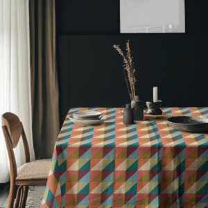 Aranżacja jadalni ze stołem nakrytym kolorowym obrusem i naczyniami