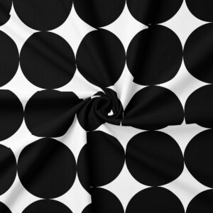 Detal materiału pokazujący duże czarne kółka na białym tle