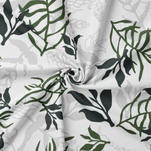 Zbliżenie na fakturę tkaniny i szczegóły liściastego nadruku w odcieniach zieleni