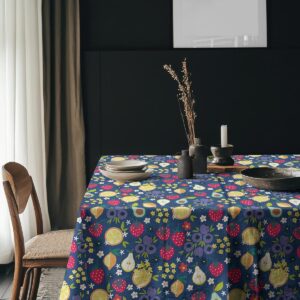 Aranżacja stołu z obiadem na obrusie w owocowy wzór i ciemnym tłem ściany