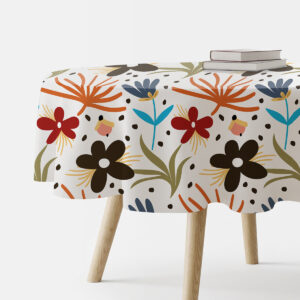 okrągły obrus na stole z kolorowym rysunkowym wzorem kwiatów widok z boku