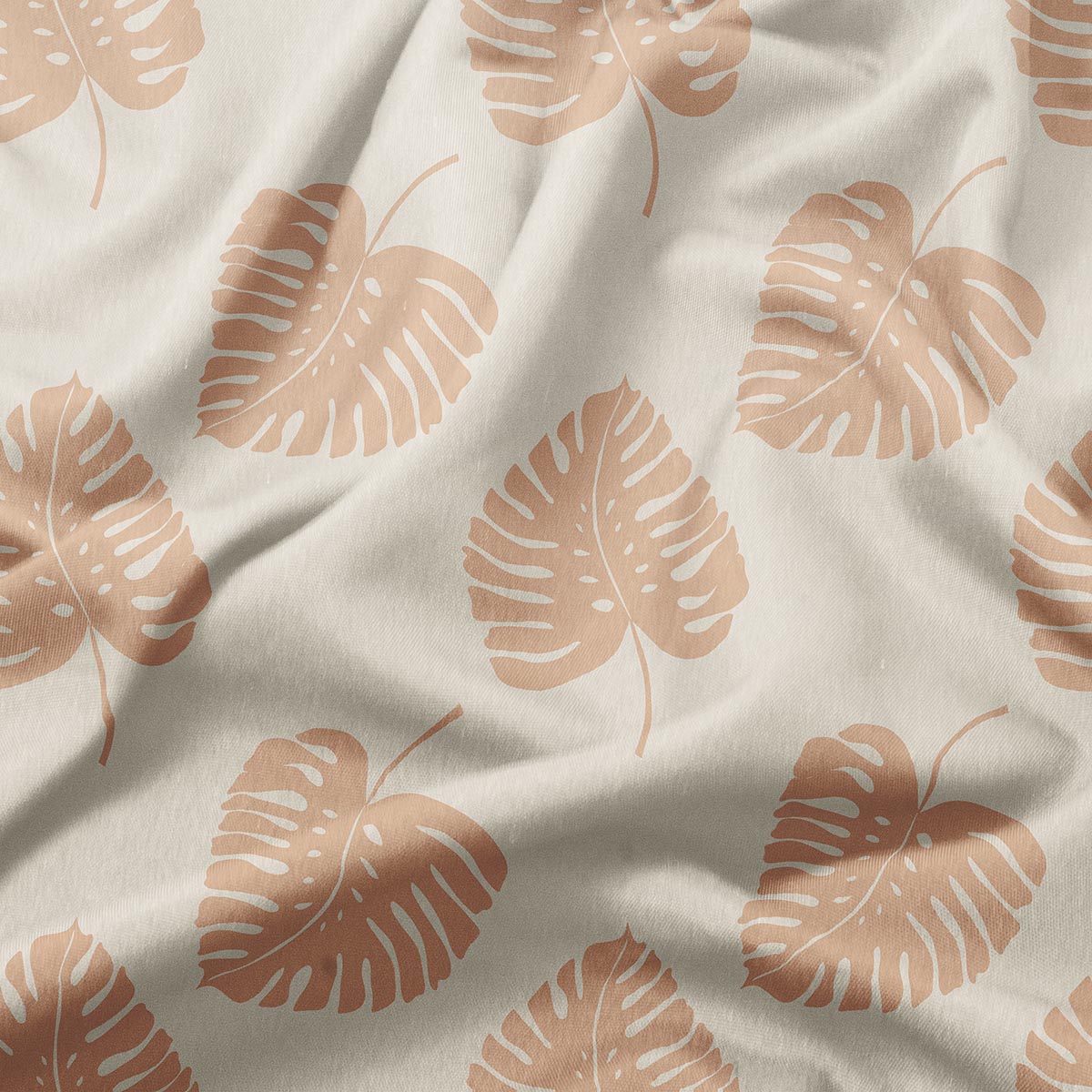 zbliżenie tkaniny z nadrukiem dużych liści i widoczną fakturą materiału